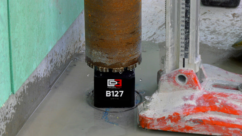 Core drill block being drilled on concrete floor